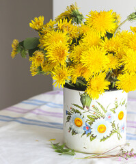 Yellow dandelions in a rustic vase - 509867088