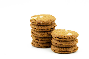 Stacked Oatmeal Cinnamon cookies with nuts isolated on white background. Sweet delicious biscuits crunchy. Homemade bakery, chrismas cookies concept