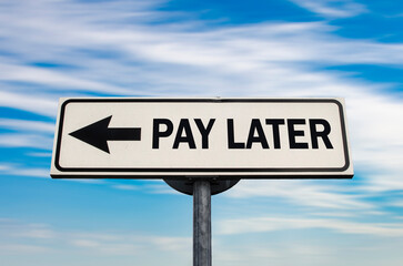 Pay later road sign, arrow on blue sky background. One way blank road sign with copy space. Arrow...