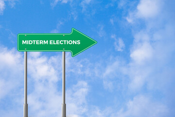 Mid term elections direction arrow road sign board with blue sky background, USA midterm election concept background
