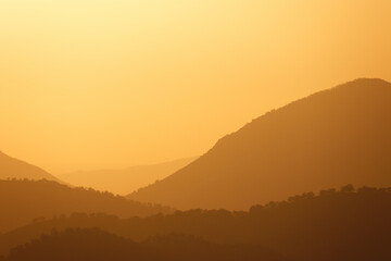 Golden hour before sunset in the mountains, rolling hills and horizons for inspiration
