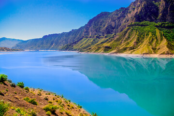 Obraz premium a beautiful view of the mountain wide river on a sunny summer day, blue skies and high mountains. Beautiful postcard, illustration for travel magazines