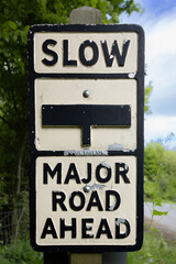 Naklejka premium Slow, major road ahead sign at Bolton Abbey railway station, Yorkshire, UK