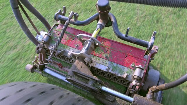 top view video of a lawnmower engine working on the golf course, motor machine job cutting grass golf course, Lawn care staff before the golf tournament, Big mowers works fast.