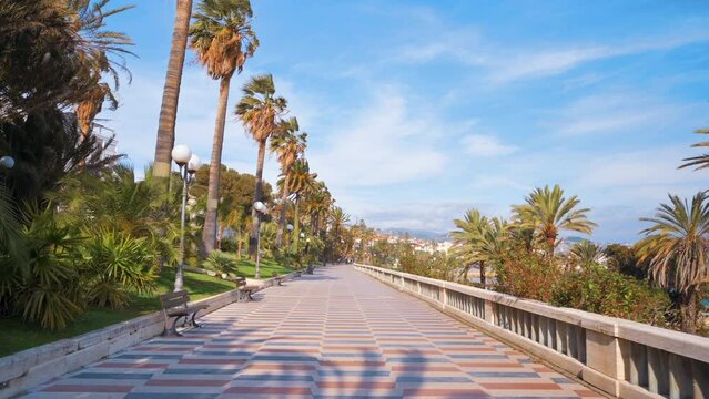 Mediterranean sea coast in Sanremo, Italy. Embankment street with a lot of greenery