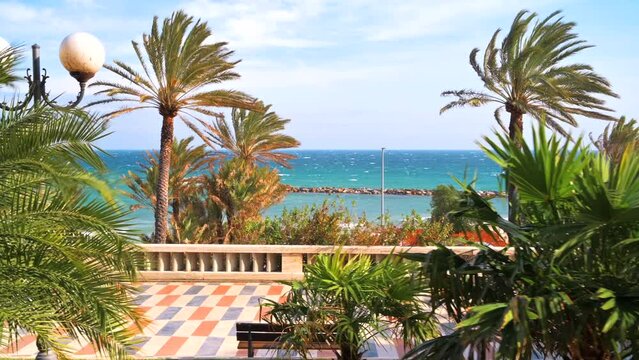 Mediterranean sea coast in Sanremo, Italy. Embankment street with a lot of greenery