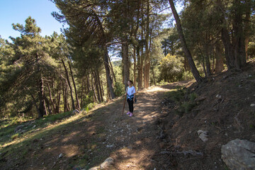 Obraz premium 1A middle-aged Caucasian woman hiking in the Sierra de Cazorla. Concept of the lifestyle of middle-aged people.