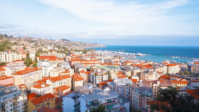 Cityscape of Sanremo from a view point, Italy. Residential buildings made in classic style, Mediterranean sea coast and sea port