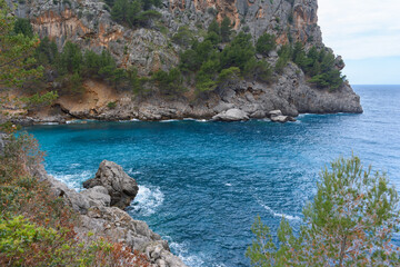 Fototapeta na wymiar Turquoise sea water and cliffs in Sa Calobra, Mallorca, Spain