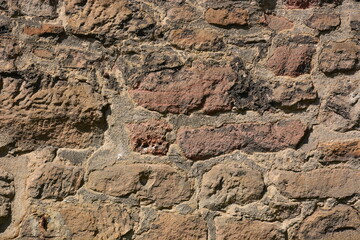 Wall made of reddish stones of irregular form