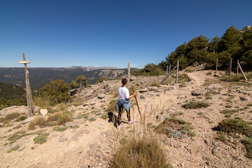 A middle-aged woman hiking the trails of the Sierra De Cazorla, Spain. Nature tourism concept.