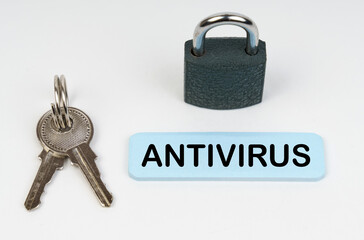 On a white surface there is a lock, keys and a blue sign with the inscription - Antivirus