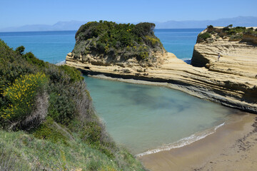 ROCKY BEACH IN SIDARI ON THE ISLAND OF CORFU IN GREECE.