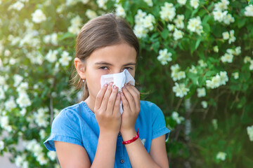 The child is allergic to flowers. Selective focus.