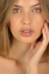 Hair and skin care. Close-up portrait of beautiful sensual young woman
