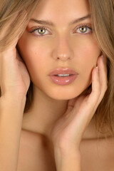Hair and skin care. Close-up portrait of beautiful sensual young woman