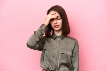 Young Ukrainian woman isolated on pink background with headache
