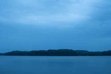 Beautiful evening nearby the lake with blue clouds