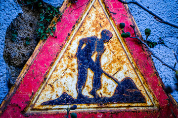 men at work sign at a construction site