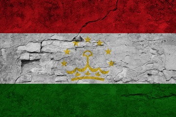 Patriotic cracked wall background in colors of national flag. Tajikistan