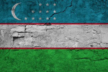 Patriotic cracked wall background in colors of national flag. Uzbekistan