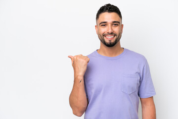 Young Arab handsome man isolated on white background pointing to the side to present a product