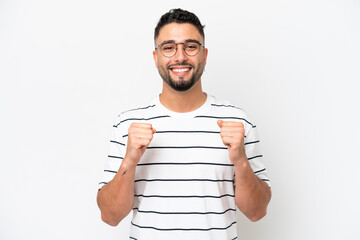 Young Arab handsome man isolated on white background celebrating a victory in winner position