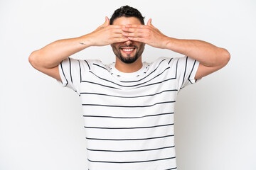 Young Arab handsome man isolated on white background covering eyes by hands and smiling
