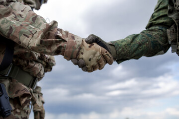 Fototapeta na wymiar Handshake of two military soldiers