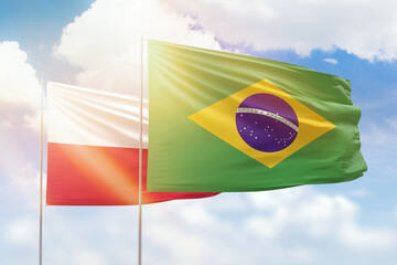 Sunny blue sky and flags of brazil and poland