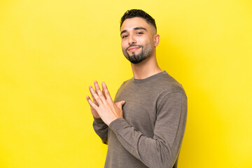 Young Arab handsome man isolated on yellow background scheming something