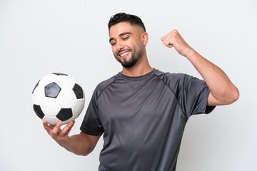 Arab young football player man isolated on white background celebrating a victory
