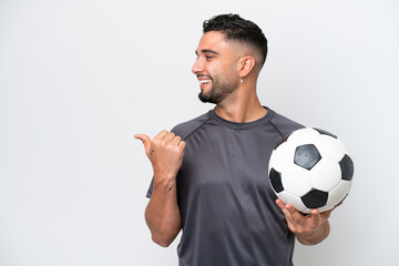 Arab young football player man isolated on white background pointing to the side to present a...