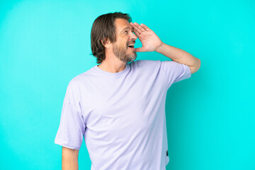 Senior dutch man isolated on blue background smiling a lot