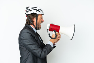 Business senior man with a bike helmet isolated on white background shouting through a megaphone