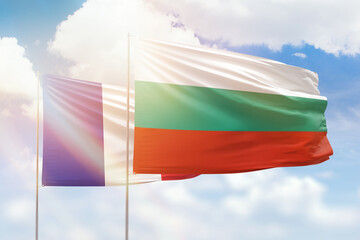 Sunny blue sky and flags of bulgaria and france