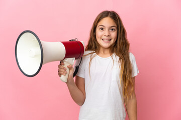 Child over isolated pink background holding a megaphone and with surprise expression