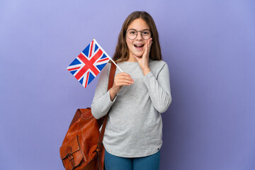 Child holding an United Kingdom flag over isolated background with surprise and shocked facial expression