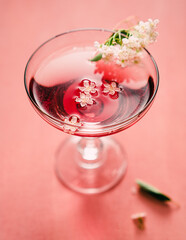 glass of champagne rose with flowers