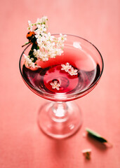 glass of champagne rose with flowers