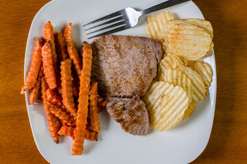 tuna steak with sweet potato fries and potato chips