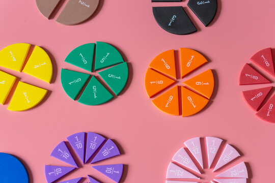 Multicolored fractions, on pink background. Interesting, fun math for kids. Education, back to school concept