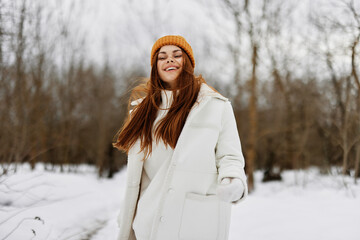 cheerful woman red hair walk in the fresh winter air Walk in the winter forest