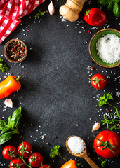 Food frame, ingredients for cooking. Food cooking background on black stone table. Fresh...