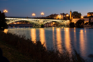 Fototapeta na wymiar Triana bridge city and river