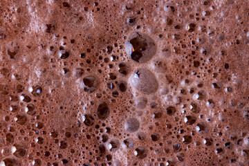 Chocolate milk texture in glass cup with small bubbles