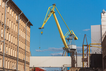 A crane in Baltic Shipyard against the blue sky - Saint Petersburg, Russia.