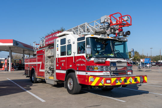 
Pearland, TX, USA - March 10, 2022: Pearland Fire Department  truck parking near a gas station. 
