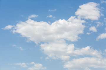 Naklejka na ściany i meble Dense white cloud in the blue sky