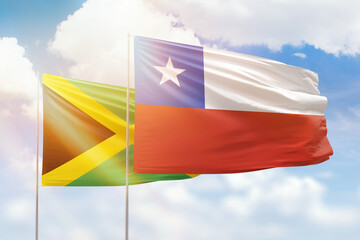 Sunny blue sky and flags of chile and jamaica